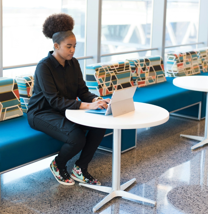 A team member working on a laptop outside the office
